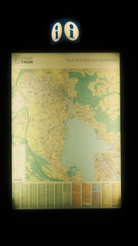A glowing map of Thun, Switzerland, displayed outdoors at night.