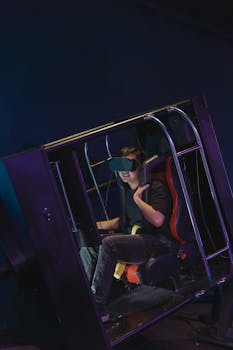 A person using a VR headset inside a motion simulator, immersed in virtual reality.