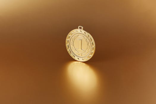 Close-up image of a golden number one medal on a soft golden background.